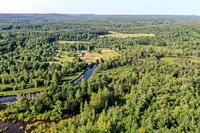 09 - high view of property facing north slightly west of previous shot - eastern half of pond in view